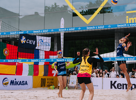 WEVZA Frau springt und schlägt Volleyball über das Netz